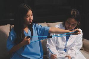 Two women in scrubs sitting on a couch with a blue ribbon photo