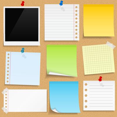 Paper notes, sticky papers an photo frames on bulletin board