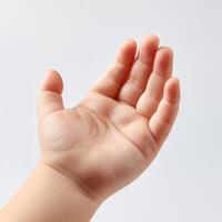 A child's hand is outstretched with a white background photo