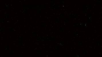 Radiant golden glitter falling gently in a dark abstract scene perfect for premium event graphics celebration templates or elegant motion backgrounds in high resolution. video