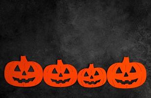 Halloween flat lay with felt pumpinks in black concrete background.Banner with place for text. photo