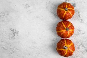 harvest flatlay with pumpkins on white concrete background.Template with place for text.Selective focus. photo