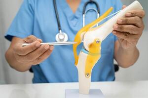 doctor holding spinal nerve and bone model, Lumbar spine displaced herniated disc fragment for treatment medical in orthopedic photo
