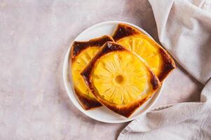 Sweet homemade pineapple tarts on a plate on the table top view photo
