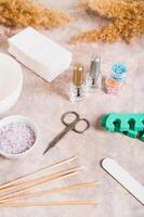 Set of items for manicure and pedicure on a table vertical view photo