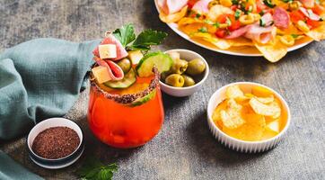 Cocktail and snack in one serving in a glass on the table web banner photo