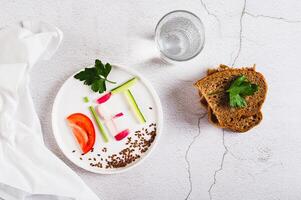 Concept diet on a plate of low-calorie foods on the table top view photo