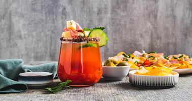 Snacktails with a cheese, salami, olive and vegatables in a glass on the table web banner photo