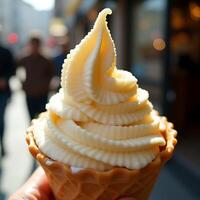 Holding Vanilla Soft Serve Ice Cream Cone on a Sunny Day photo