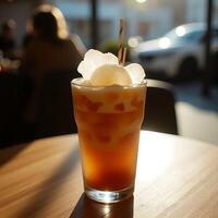 Iced Tea with Lychee Refreshment on Wooden Table in Cafe photo
