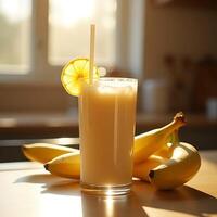 Making Banana Smoothie with Lemon in Glass on Table photo