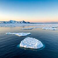 Icebergs floating in the ocean with mountains in the background photo