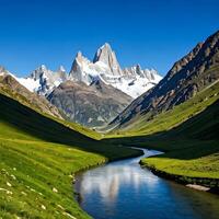 A river runs through a valley in front of a mountain range photo