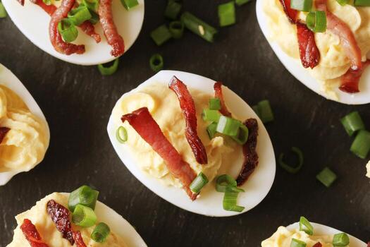 Bacon Deviled Eggs on black background photo