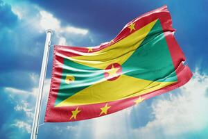 The flag of grenada is flying high in the sky photo