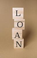 Stack of wooden blocks with the word loan written on them photo