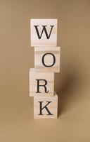 Stack of wooden blocks with the word work written photo