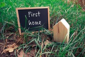 Chalkboard sign with the words First Home written on it photo