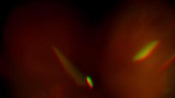 Multicolored light leaks 4k footage on black background. Lens flare leak burst overlays. Natural lighting lamp rays bokeh effect. For compositing over your footage, stylizing , transitions video