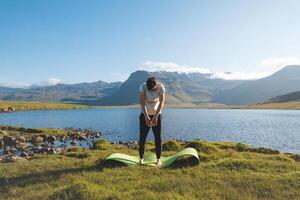 Man practices yoga to strengthen and stretch his body in the stunning Icelandic environment on the western part of the island. Exercising on the Snaefellsnes Peninsula during a amazing summer photo