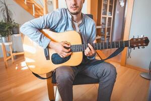 Acoustic guitar and composing new songs. Immersed in the sweet tones of the guitar. Music that heals the soul photo