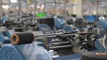 View of automated textile manufacturing machines in a factory, with spools of thread working right now video