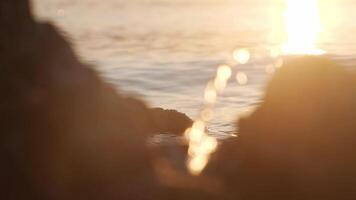 Calm sea at golden sunset, static shot, slow motion video