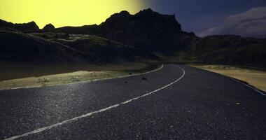 CGI Curving road through a dramatic landscape under a colorful sky at dusk video