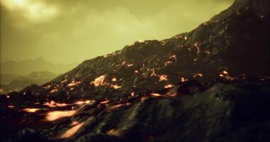 CGI Lava flowing slowly across a volcanic landscape under a hazy sky video
