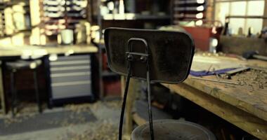 CGI Empty stool in a woodworking shop surrounded by tools and clutter video