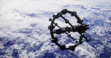 CGI Space station orbits Earth surrounded by clouds during daylight video