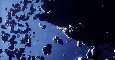 CGI Asteroids drift through space in a dynamic celestial environment video