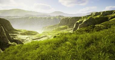 CGI Lush green valley surrounded by rocky hills in bright sunlight video