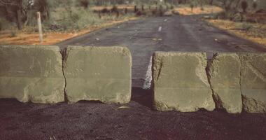 CGI Road blocked by concrete barriers in a remote location during daylight video