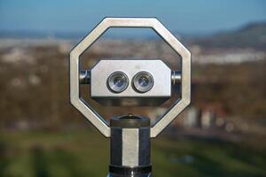 Sightseeing tower viewer, observation binoculars. Binoculars on the observation deck with panoramic views of the city. photo