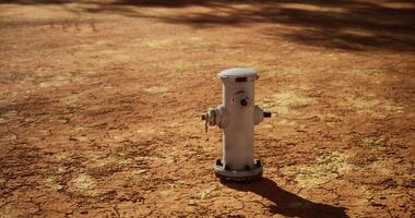 CGI Fire hydrant on dry cracked earth during a sunny day in a rural area video