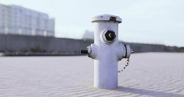 CGI White fire hydrant on sandy beach area in clear daylight video