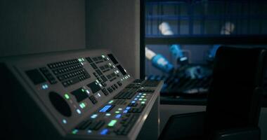 CGI Control panel in an industrial setting with robotic machinery in background video