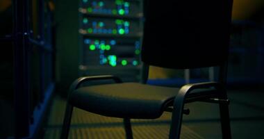 CGI Empty chair in a dimly lit server room with glowing lights at night video