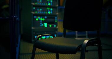 CGI Empty chair in a server room with glowing lights at night video
