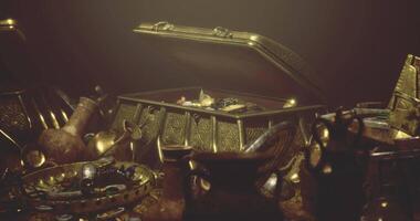 CGI Treasure chest filled with ancient artifacts and golden jewelry in dim light video