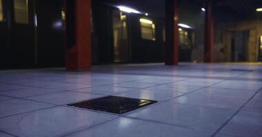 CGI View of a dimly lit underground station floor with tiles and drain cover video