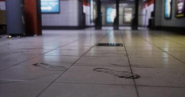 CGI Footprints on the tiled floor in a public transit station at night video