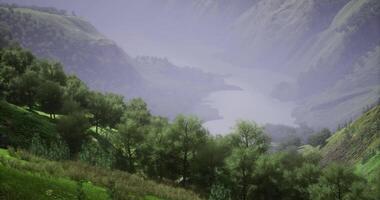 CGI Lush green hills surrounding a serene river valley on a misty morning video