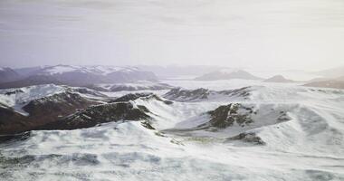 CGI Majestic snow covered mountains under soft sunlight in a serene landscape video