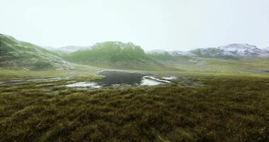 CGI Vast green landscape with a shimmering body of water in a mountainous region video