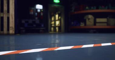 CGI Warning line on warehouse floor with dim lighting in the background at night video