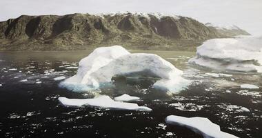 CGI Majestic icebergs float serenely near rugged cliffs in cold waters video