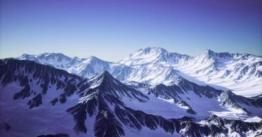 CGI Snow capped mountain range under clear sky during daylight hours video