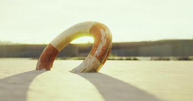 CGI Lifebuoy on sandy beach at sunset with soft light illuminating the scene video
